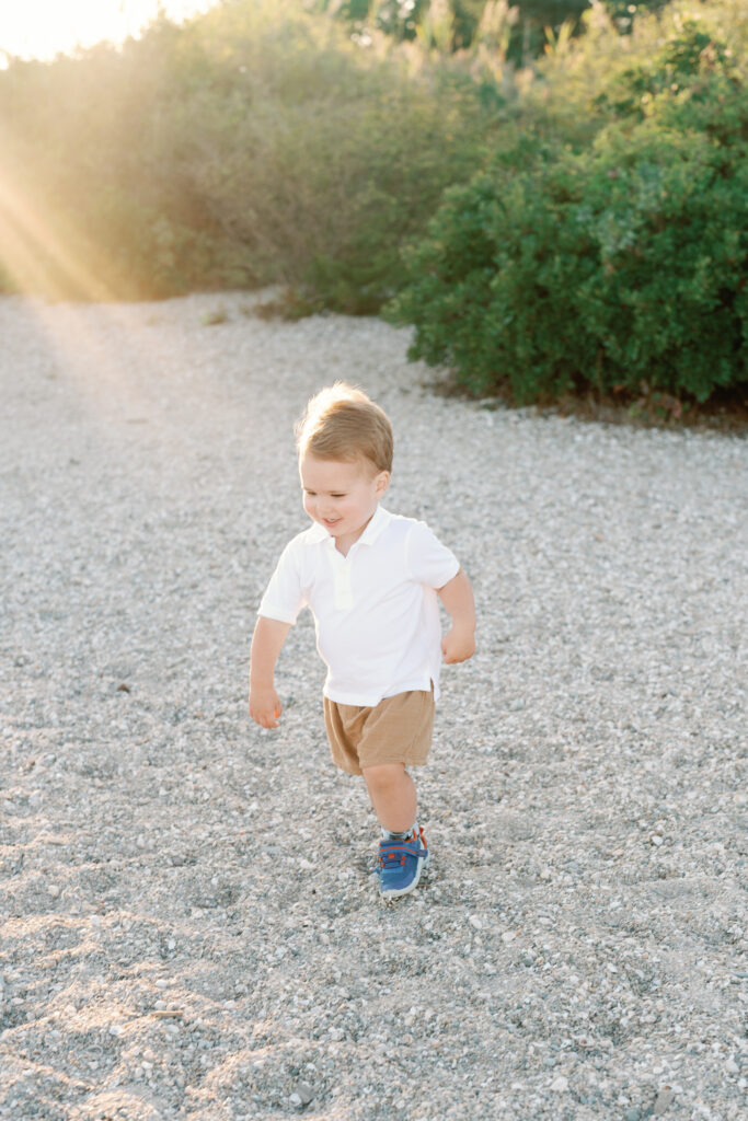 Lifestyle family photography session at Hammonasset Beach State Park featuring candid interaction and movement
