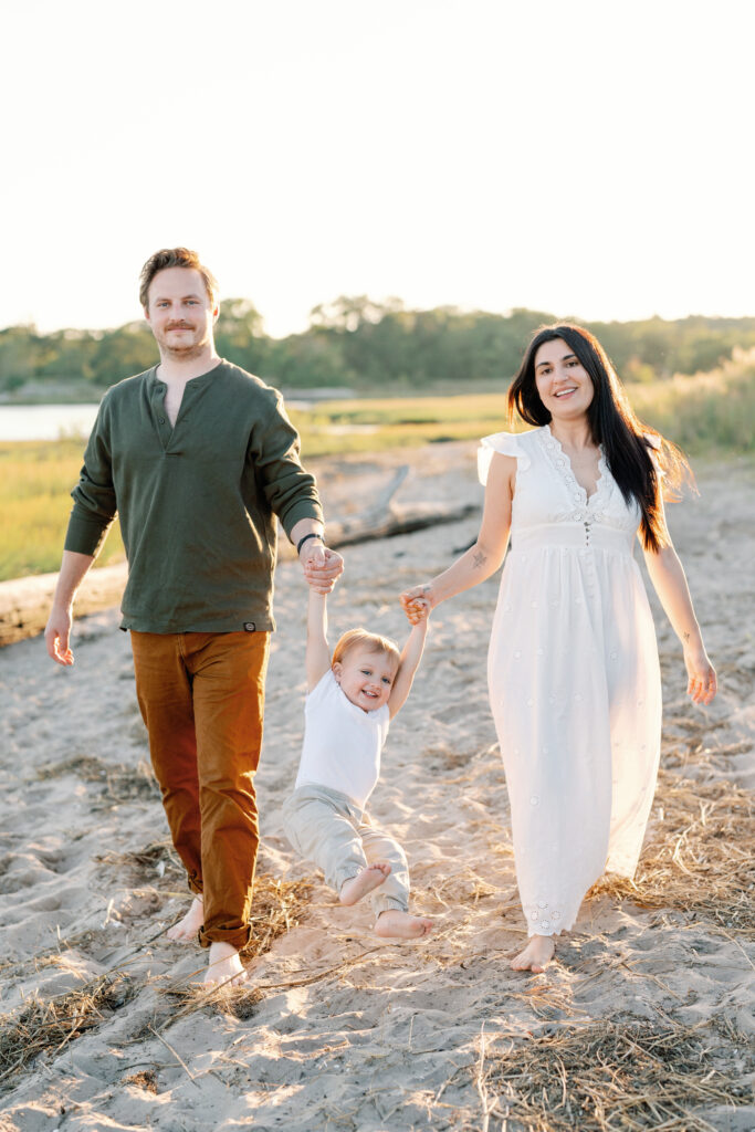 Coastal New England family photos in Guilford CT with soft breeze, sandy textures, and pastel skies