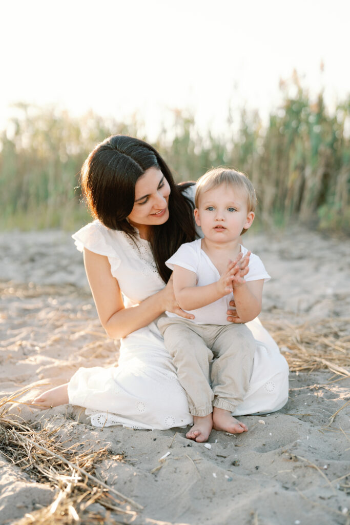 Coastal New England family photos in Guilford CT with soft breeze, sandy textures, and pastel skies