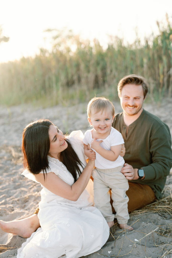 Coastal New England family photos in Guilford CT with soft breeze, sandy textures, and pastel skies
