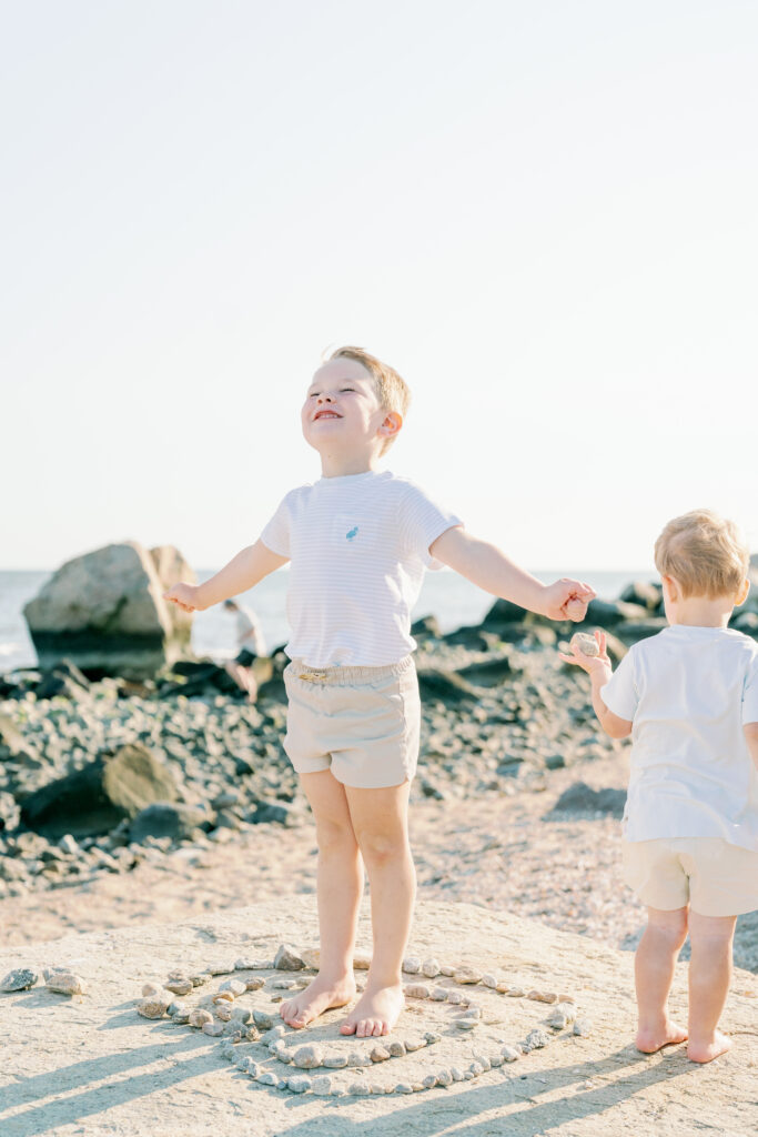 Lifestyle family photography session at Hammonasset Beach State Park featuring candid interaction and movement