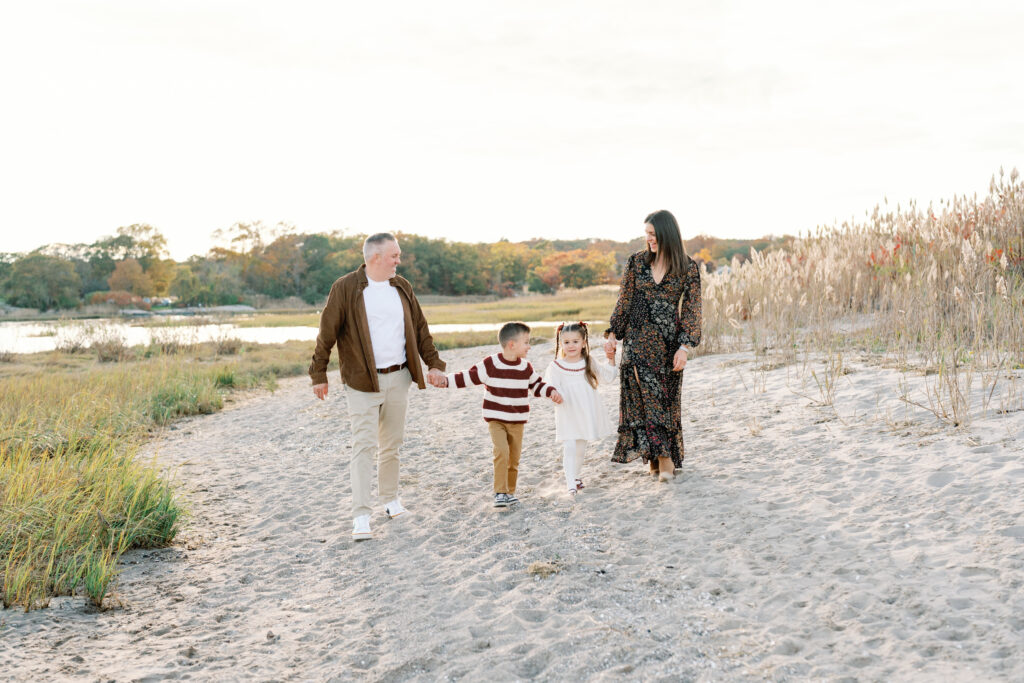 Family of four enjoying a sunset beach session in Guilford Connecticut with soft coastal light and ocean views