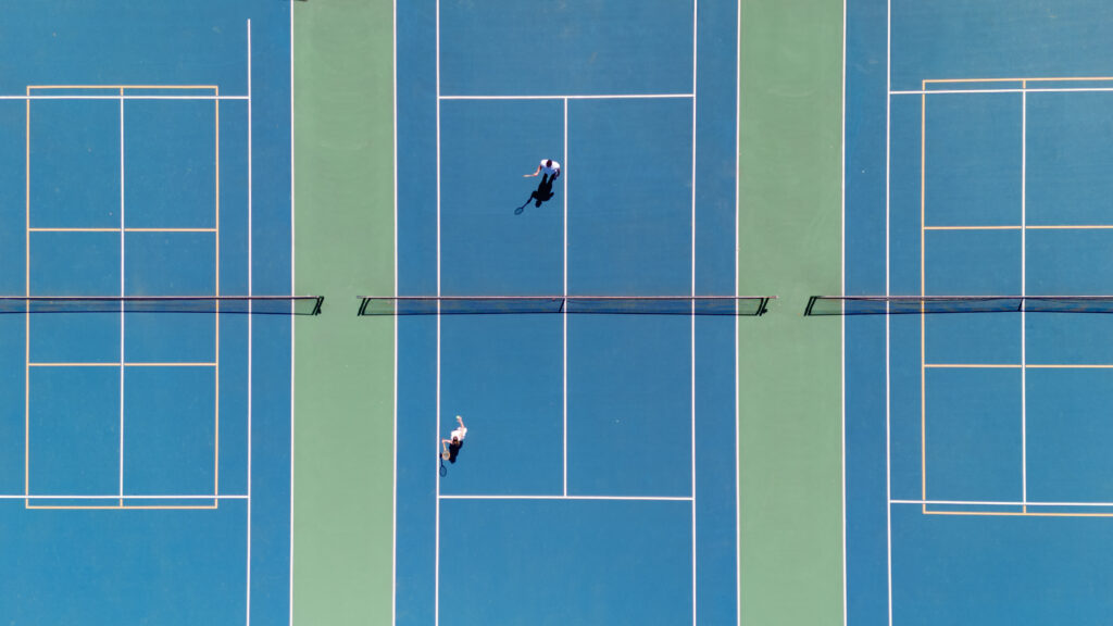Romantic New England engagement photos of couple playing pickleball, birds-eye view