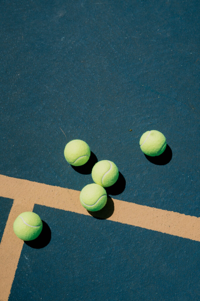Coastal New England engagement session with couple enjoying pickleball game